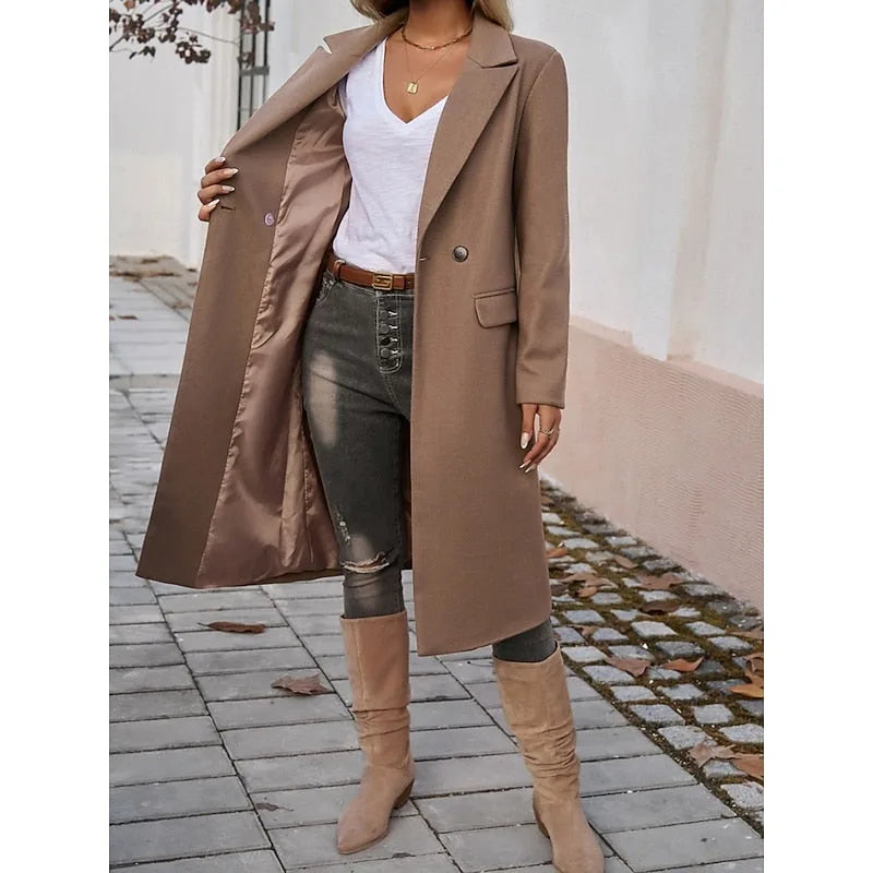Close-up of a brown longline coat unbuttoned to reveal a satin lining, worn open over a white tee