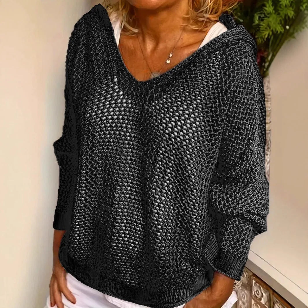 Product shot of the khaki open-knit hooded jumper on a model, three-quarter front view