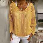 Product shot of the red open-knit hooded jumper on a model, front view showing batwing sleeves
