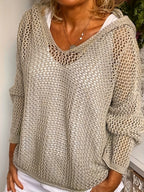 Close-up front view of the khaki crochet-style knit jumper showing the hood and V-neckline texture