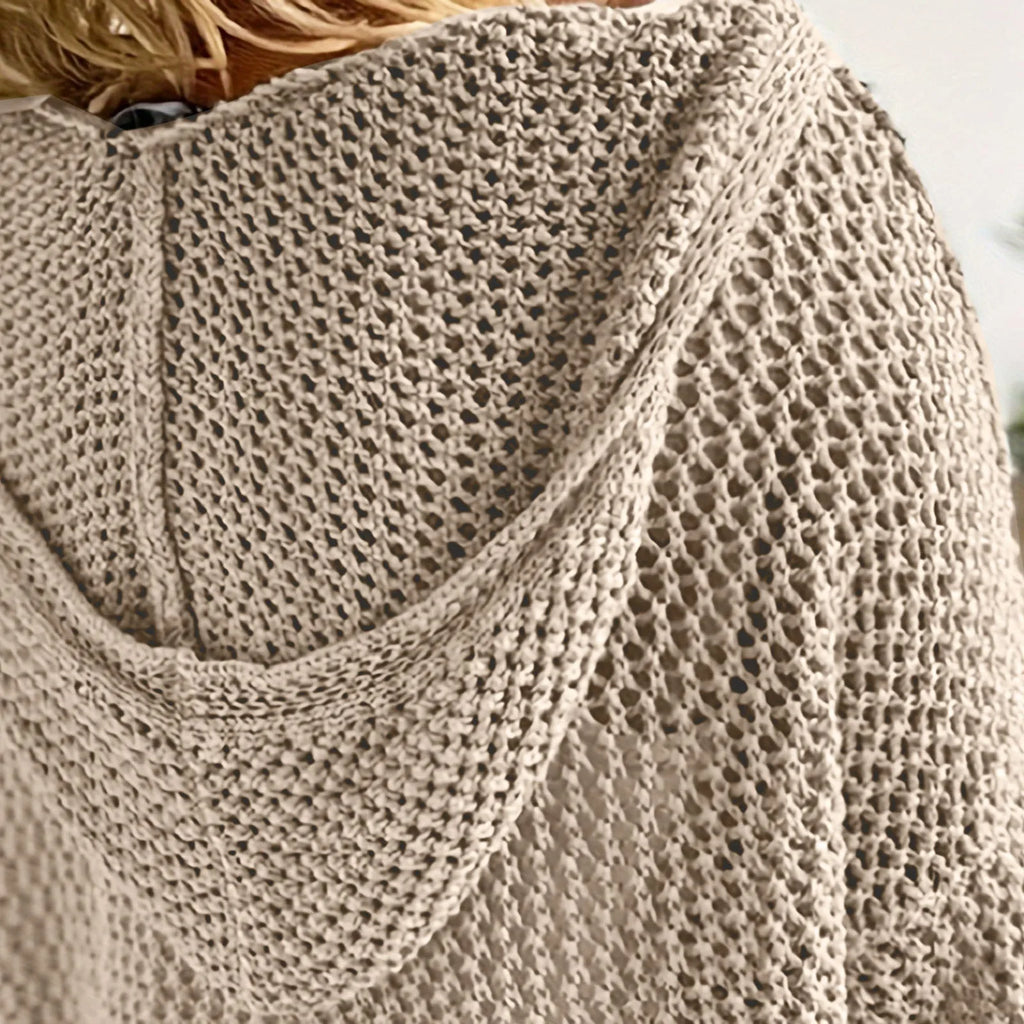 Close-up of the khaki open-knit fabric and hood seam, showing the chunky crochet-style stitch detail