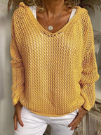 Model wears the yellow open-knit hooded jumper over a white top, front view showing relaxed fit