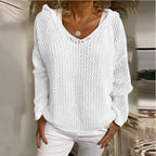 Model wears the white open-knit hooded jumper paired with white trousers, front view