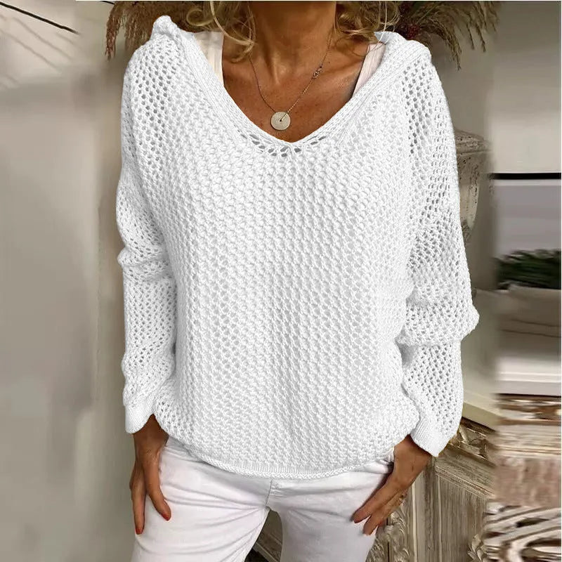 Model wears the white open-knit hooded jumper paired with white trousers, front view
