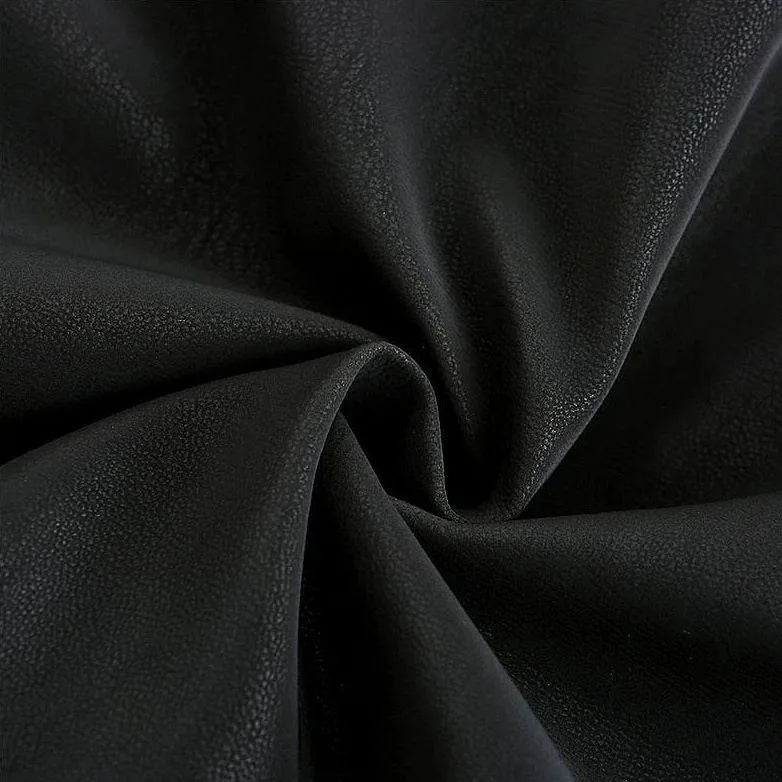 Close-up texture of the smooth black faux leather material, shown draped and folded