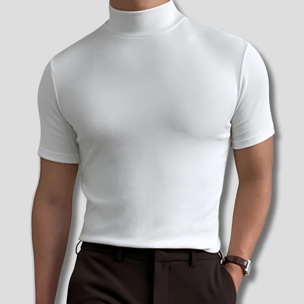 Close-up front view of a man wearing a white mock-neck short-sleeve top with smooth ribbed collar and dark trousers.