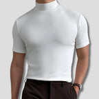 Close-up front view of a man wearing a white mock-neck short-sleeve top with smooth ribbed collar and dark trousers.