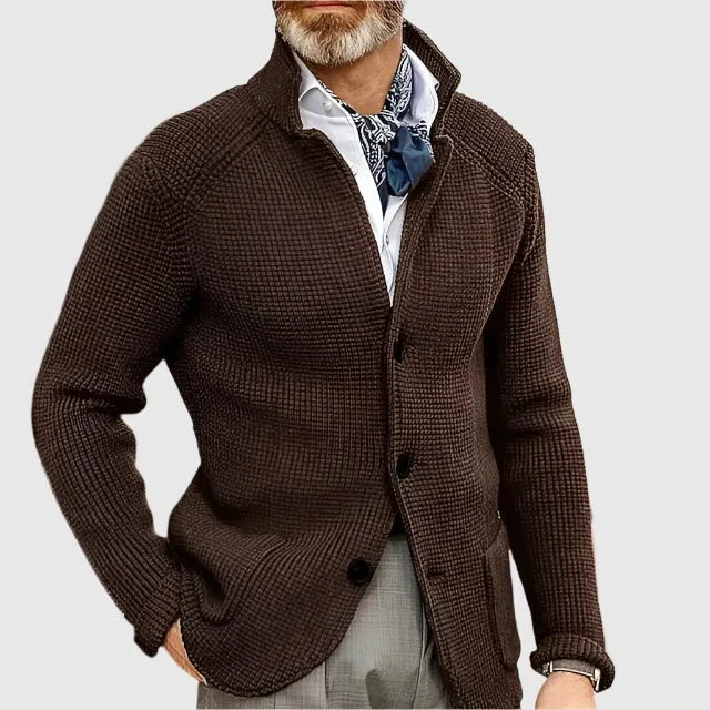 Close-up of the stand collar and top button on the navy textured knit cardigan