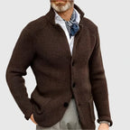 Close-up of the stand collar and top button on the navy textured knit cardigan