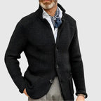 Side profile of the blue knit cardigan showing the stand collar and sleeve seam detail