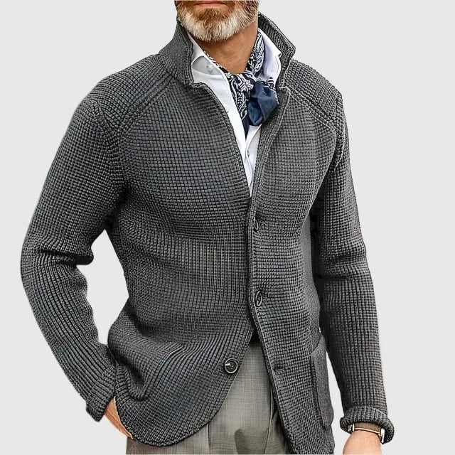 Close-up of the button fastening and knit ribbing on the navy cardigan