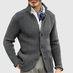 Close-up of the button fastening and knit ribbing on the navy cardigan