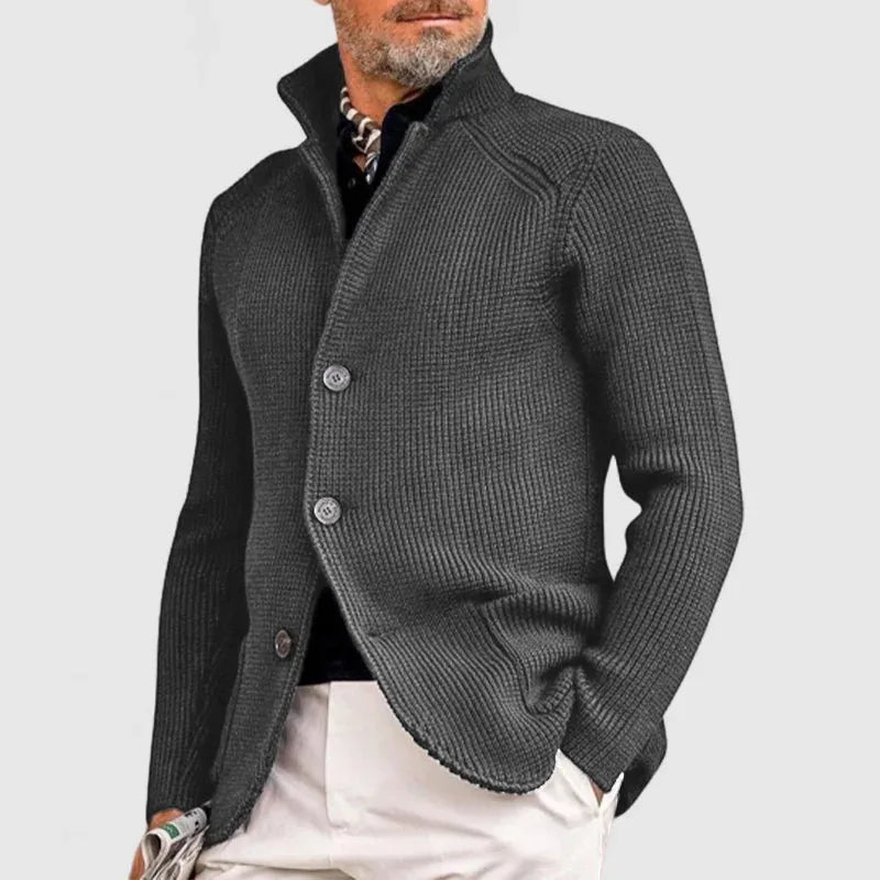 Charcoal grey waffle-knit button-front cardigan shown with white trousers