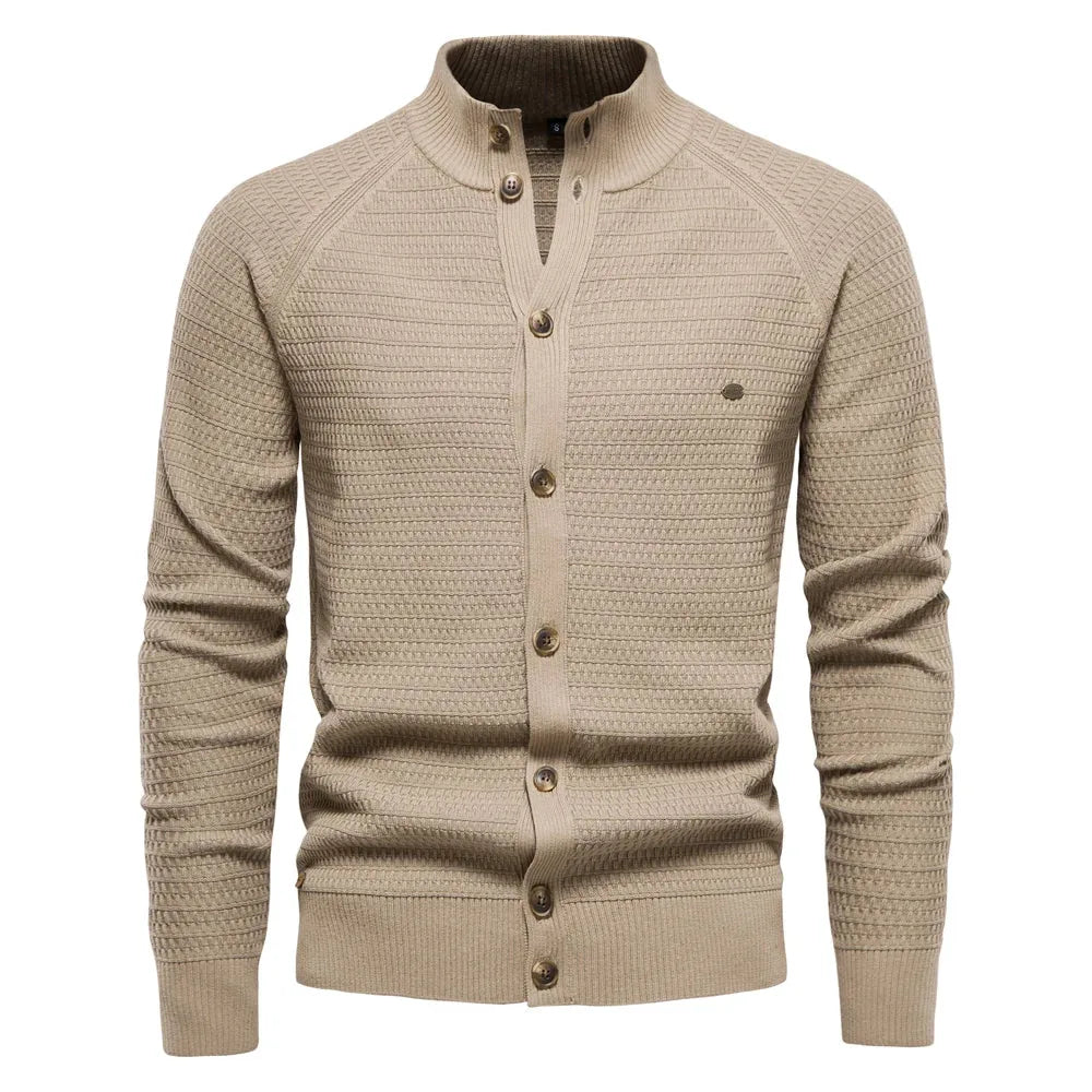 Beige knit cardigan with stand collar, raglan sleeves and brass-tone buttons, front view