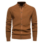 Brown textured cardigan with stand collar, button placket and subtle metal badge on the chest