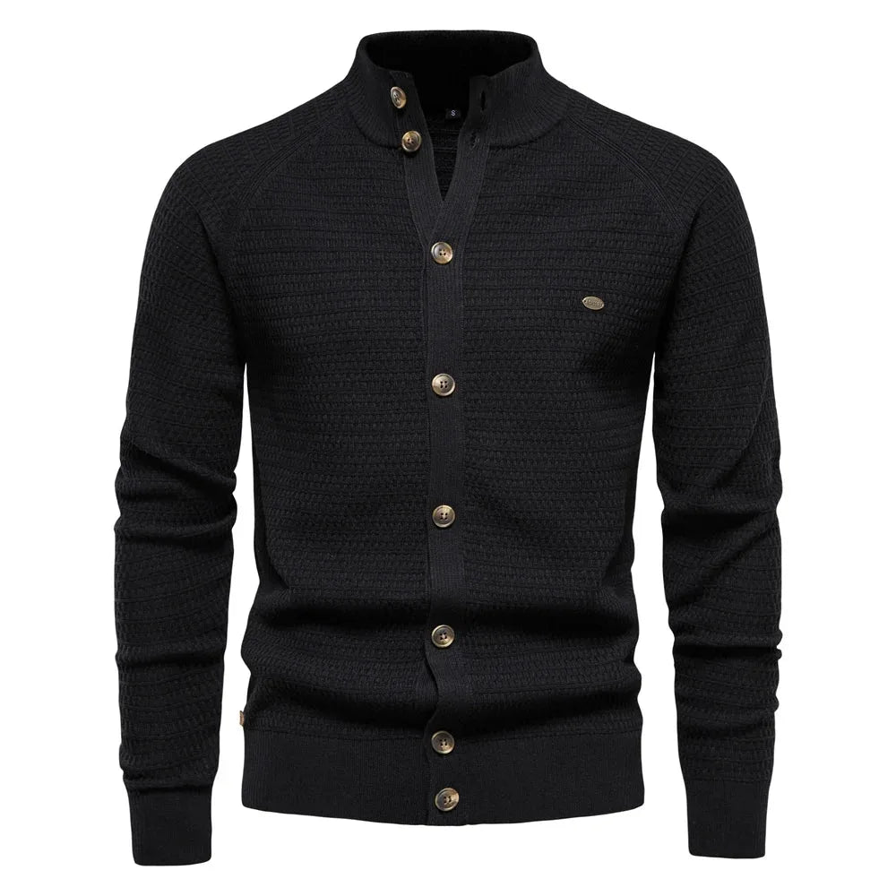 Black cable knit cardigan with stand collar, full button front and ribbed cuffs and hem