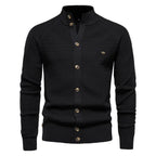 Black cable knit cardigan with stand collar, full button front and ribbed cuffs and hem