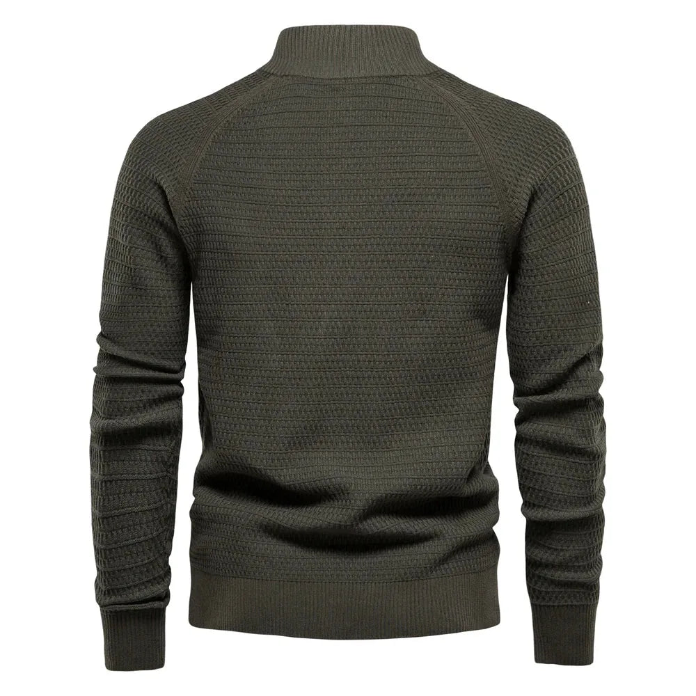 Back view of olive green knit cardigan showing textured raglan sleeves and ribbed stand collar