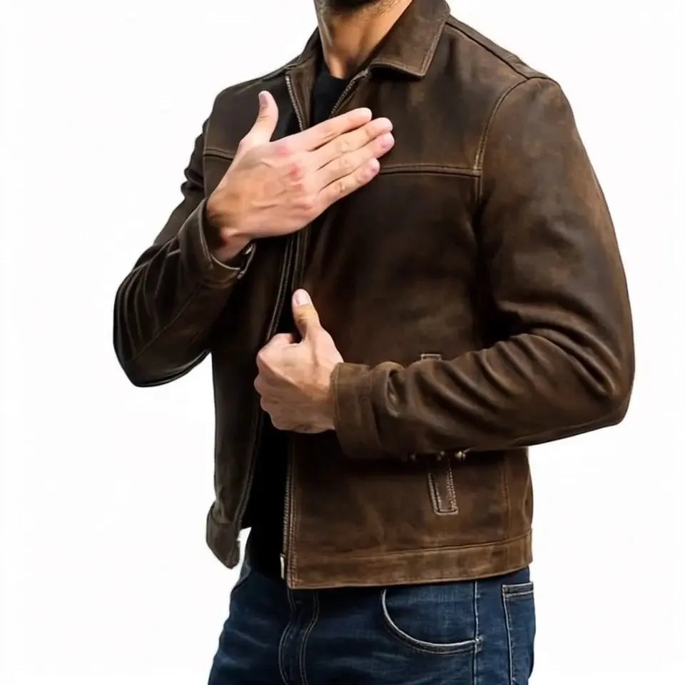 Side angle of brown leather jacket with sleeve cuff and chest pocket detail, hand resting on chest