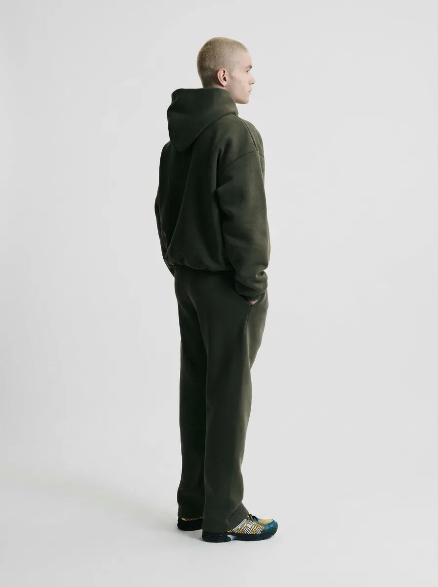 Rear view of the olive green hoodie and jogger set showing the hood shape and relaxed back silhouette