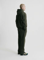 Rear view of the olive green hoodie and jogger set showing the hood shape and relaxed back silhouette
