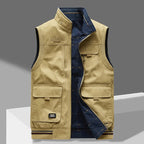 Khaki cotton gilet with stand collar and navy quilted lining visible through the open front zip