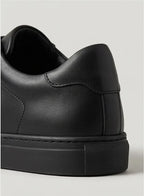 Close-up of the padded heel and textured outsole on a black trainer