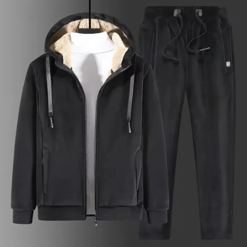 Black fleece tracksuit with hood up over a white jumper, shown on a hanger with matching joggers