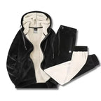 Black hooded jacket and joggers laid flat, unzipped to reveal the cream sherpa fleece interior