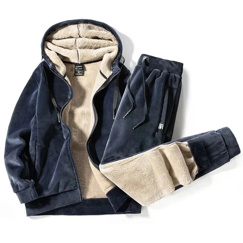 Navy blue velour hooded jacket and joggers laid flat, unzipped to show the cream fleece lining