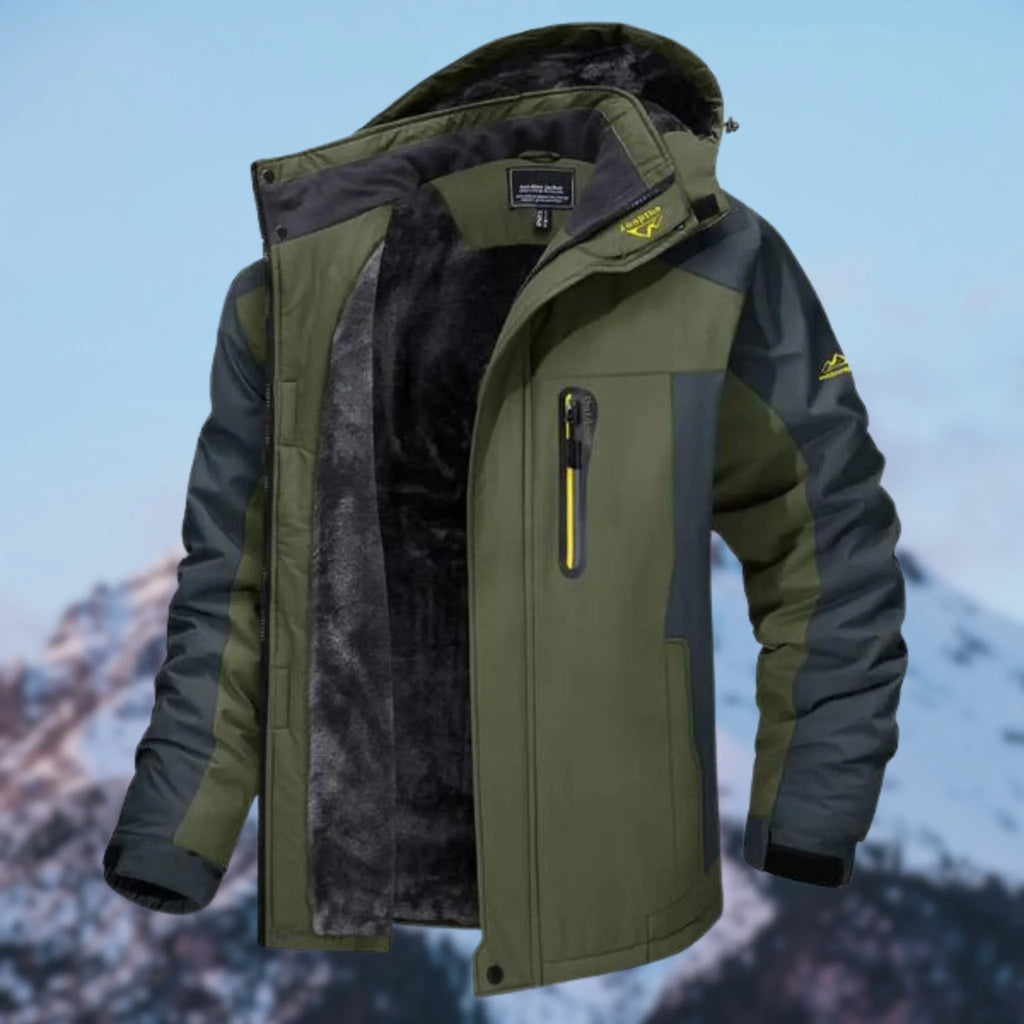 Men's khaki green winter jacket with hood open, showing black faux fur lining and zip chest pocket, mountain backdrop