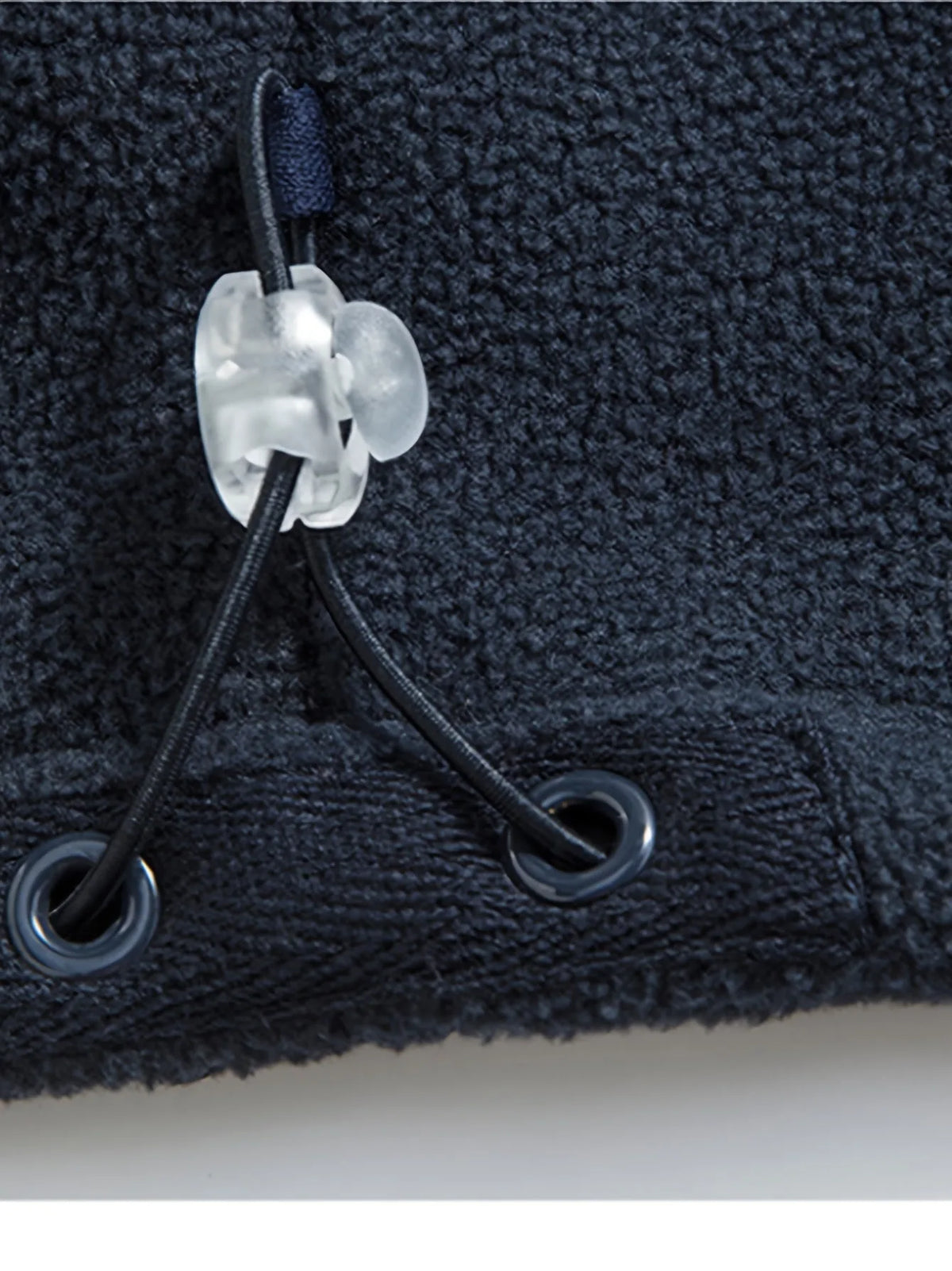 Close-up of the adjustable drawcord and toggle at the jacket hem