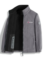 Black fleece jacket open flat, showing the embroidered flag logo on the chest and stand collar