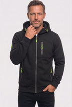 Man wearing a navy hoodie layered over a white t-shirt paired with dark trousers