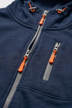 Close-up of the chest and front zip pockets with grey trims and contrast orange zip pulls