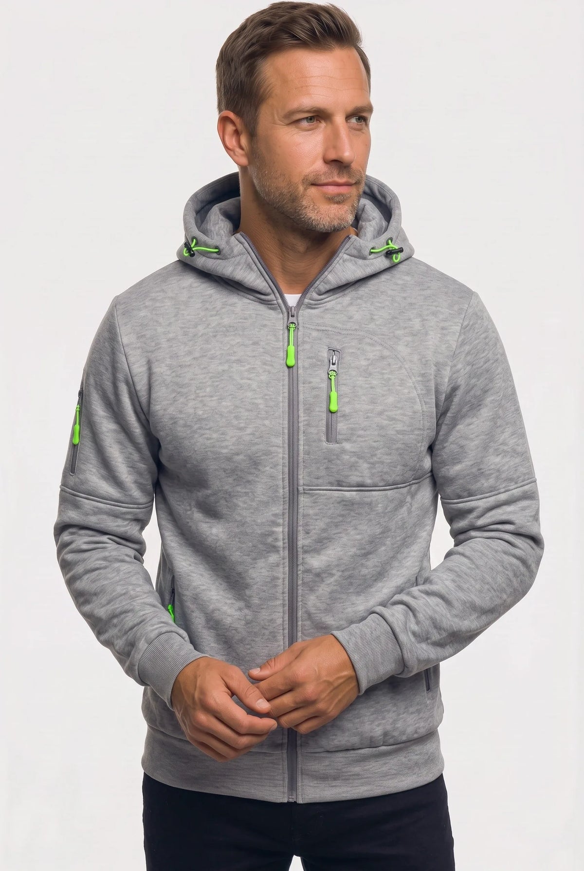 Man wearing a light grey marl full-zip hoodie with green contrast zip pulls and drawstring hood