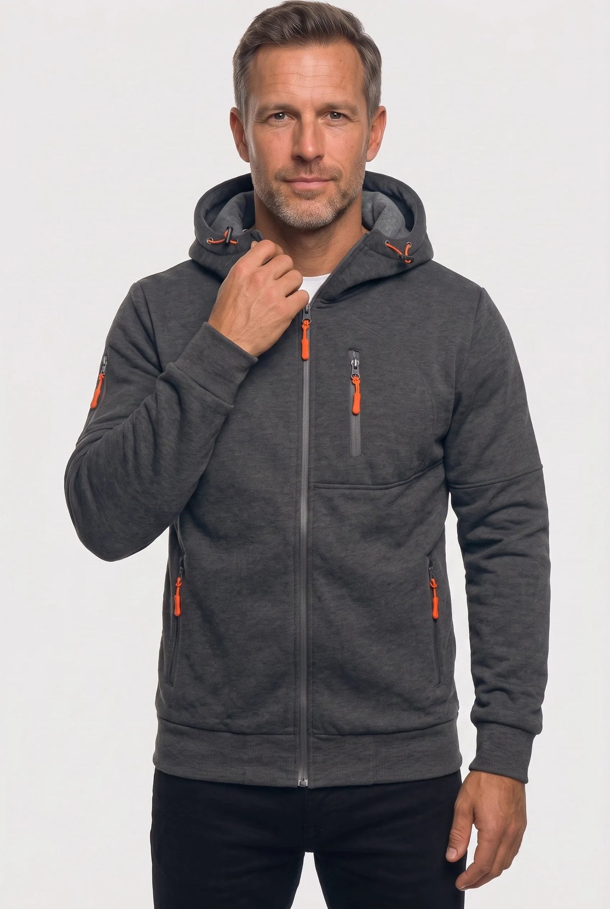 Man wearing a dark grey marl full-zip hoodie with a raised hood and orange zip pulls