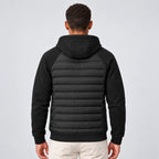 Back view showing the quilted panel and fleece-sleeved hood of the black puffer jacket