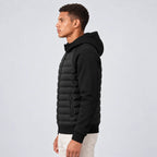 Side profile of the black hooded puffer jacket showing the raised collar and zip pocket