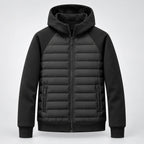 Studio front shot of the black hooded puffer jacket with zip pockets and ribbed cuffs