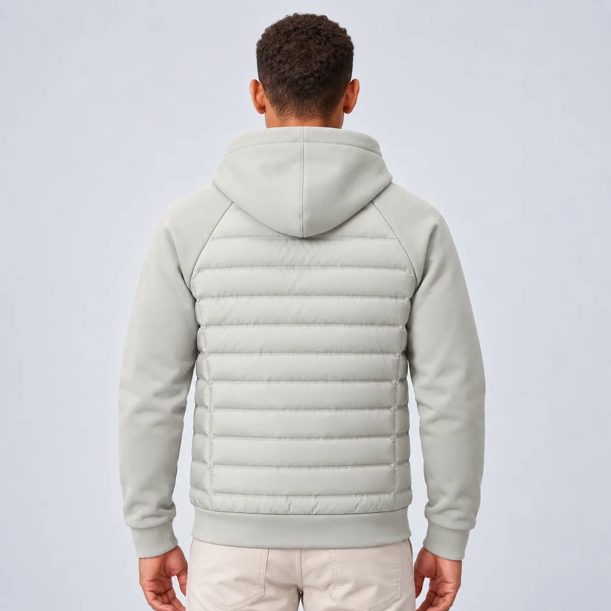Back view of the light grey hooded puffer jacket showing the fleece hood and quilted panel