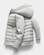 Side profile of the light grey jacket laid flat, highlighting the raised hood and zip pocket detail