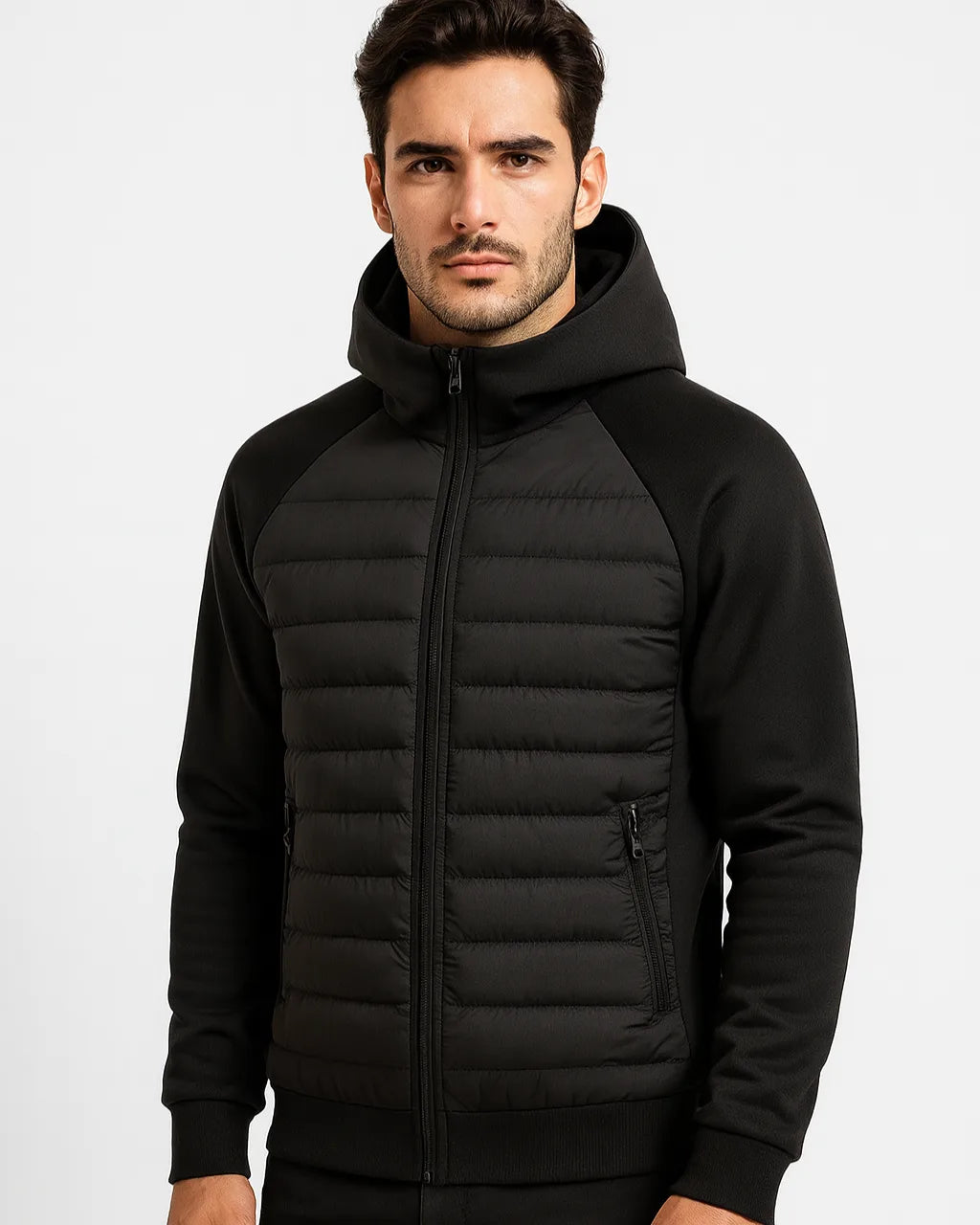 Close-up front view of a man wearing the black hooded puffer jacket, zipped up with hood raised