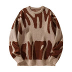 Beige knit jumper with rust brown abstract graffiti design, ribbed crewneck collar and cuffs visible
