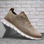 Side view of a khaki knit trainer with tan leather heel tab and chunky white lugged sole