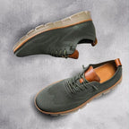 Olive green knit trainer with tan leather trim and heel pull, paired with a cream lugged sole