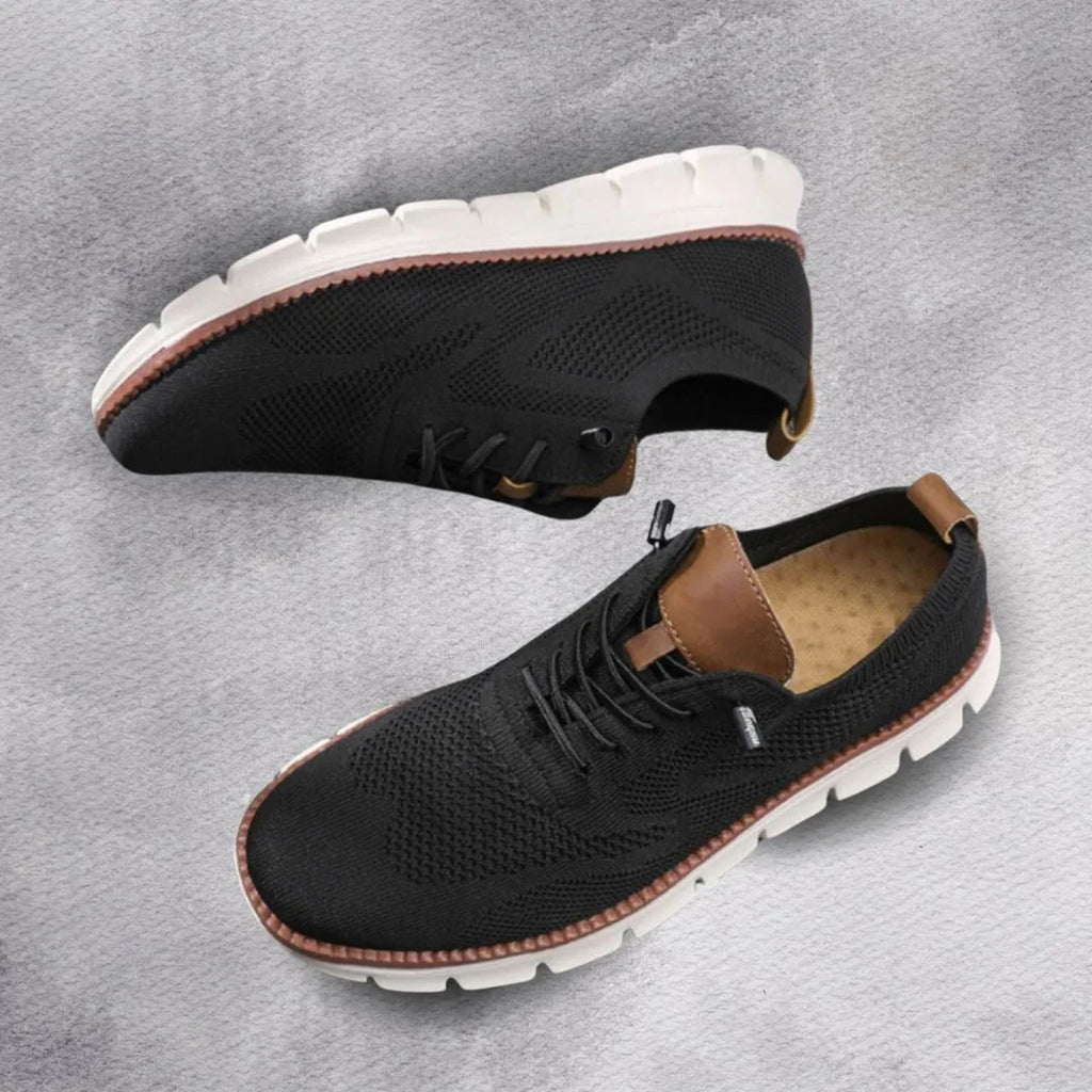 Black knit lace-up trainer with contrast tan heel tab shown from above and the side
