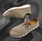 Khaki knit trainer with tan leather trim and white lugged sole photographed from above and the side