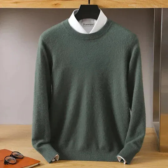 Styled flat lay of a jumper with sunglasses and leather accessories on a wooden surface