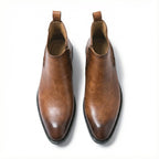 Top-down view of a pair of tan brown leather Chelsea boots highlighting the polished finish and stacked sole